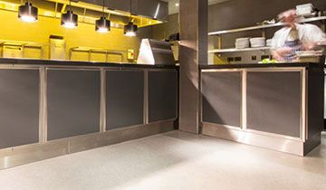 Inside a kitchen with silver and yellow decor.