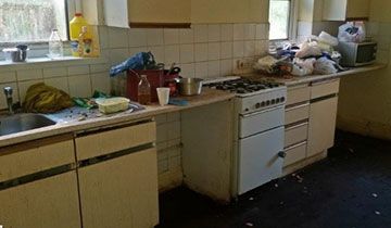 A row of cluttered kitchen units